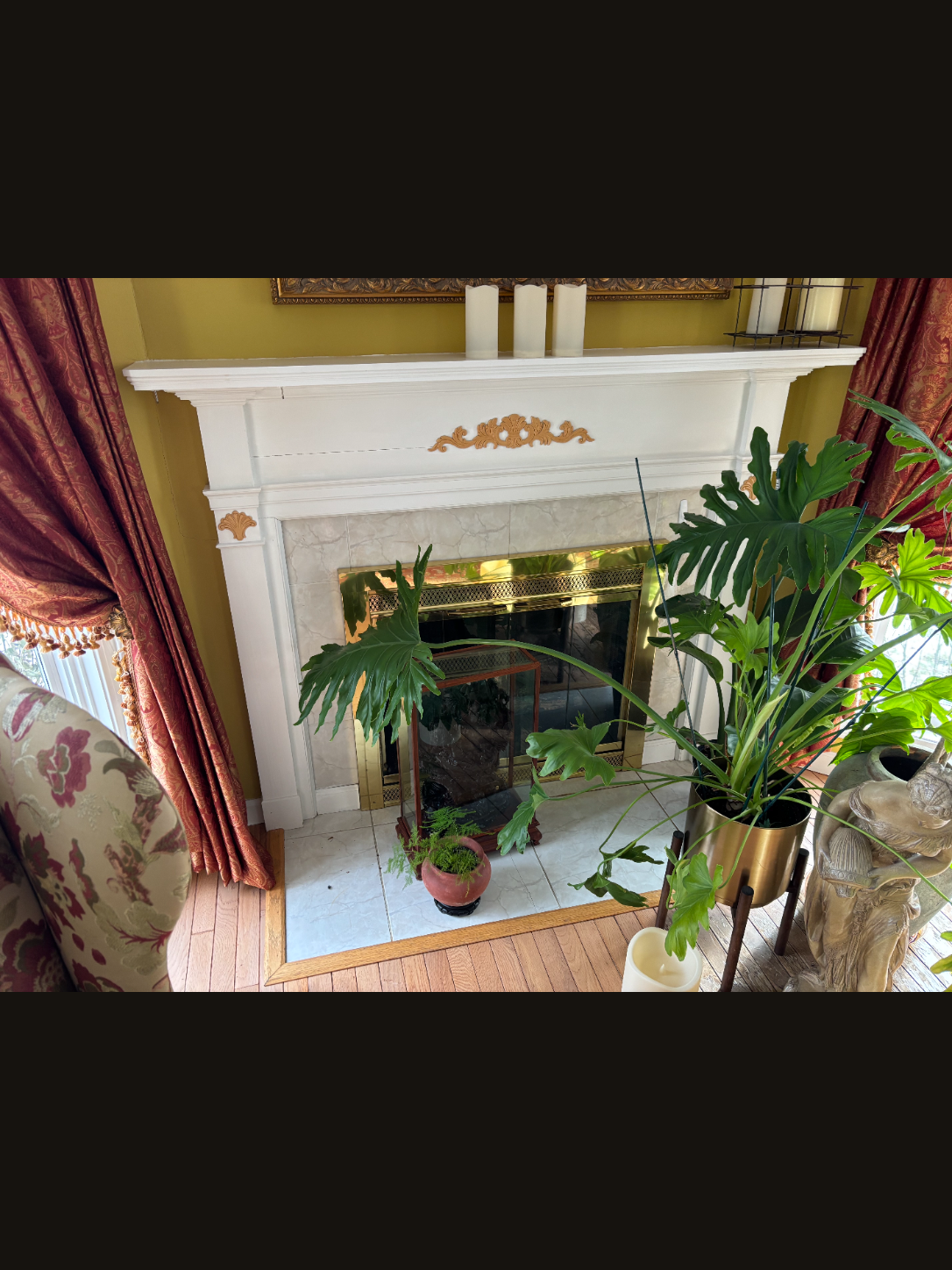 Original mantel with brass doors and tile hearth